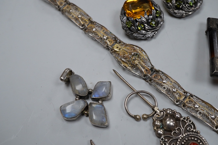 A group of silver jewels, comprising: a Scottish hardstone brooch of square outline; a pair of Arts and Crafts citrine and green tourmaline ear clips, length 2.7cm each; a silver link bracelet; a silver filigree bracelet